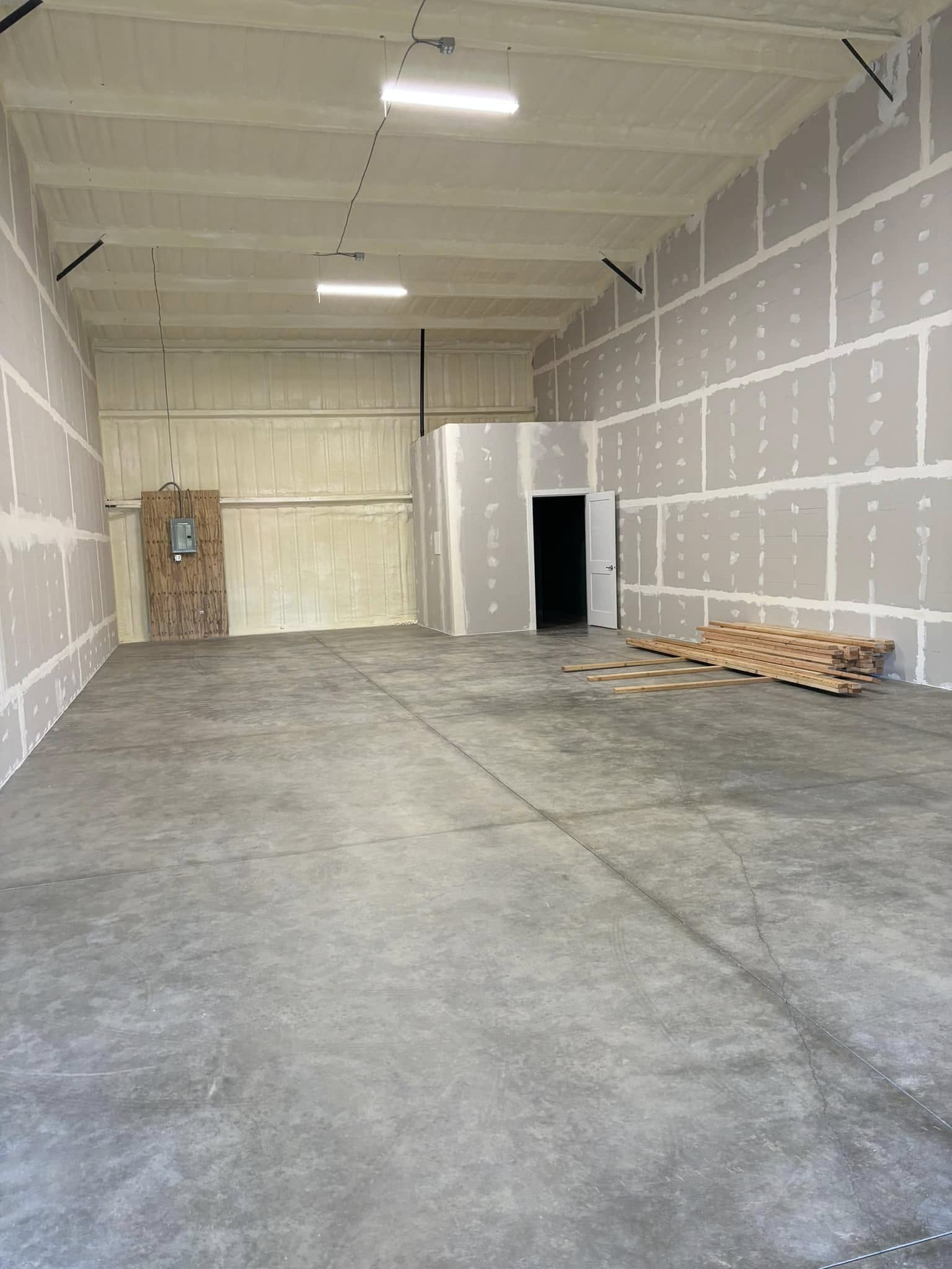Finished warehouse unit with concrete flooring and high ceilings